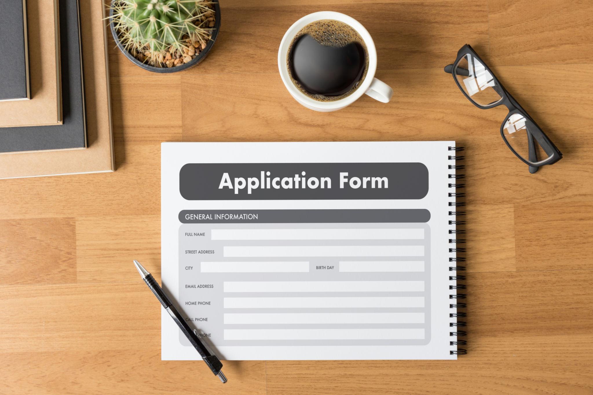 A professional desk setup showing cabin crew application documents, resume, passport photos, and checklist for cabin crew application preparation.