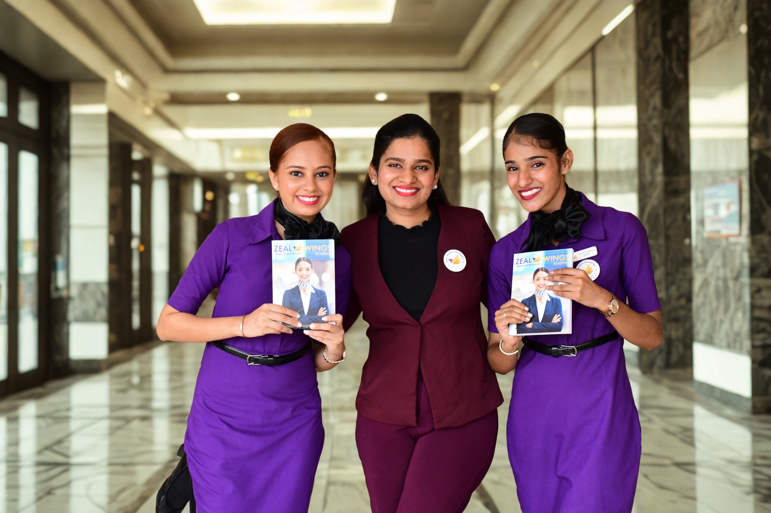 Founder Sivapriya Sivakumar with aviation students in uniform at Zeal Wings Academy Chennai