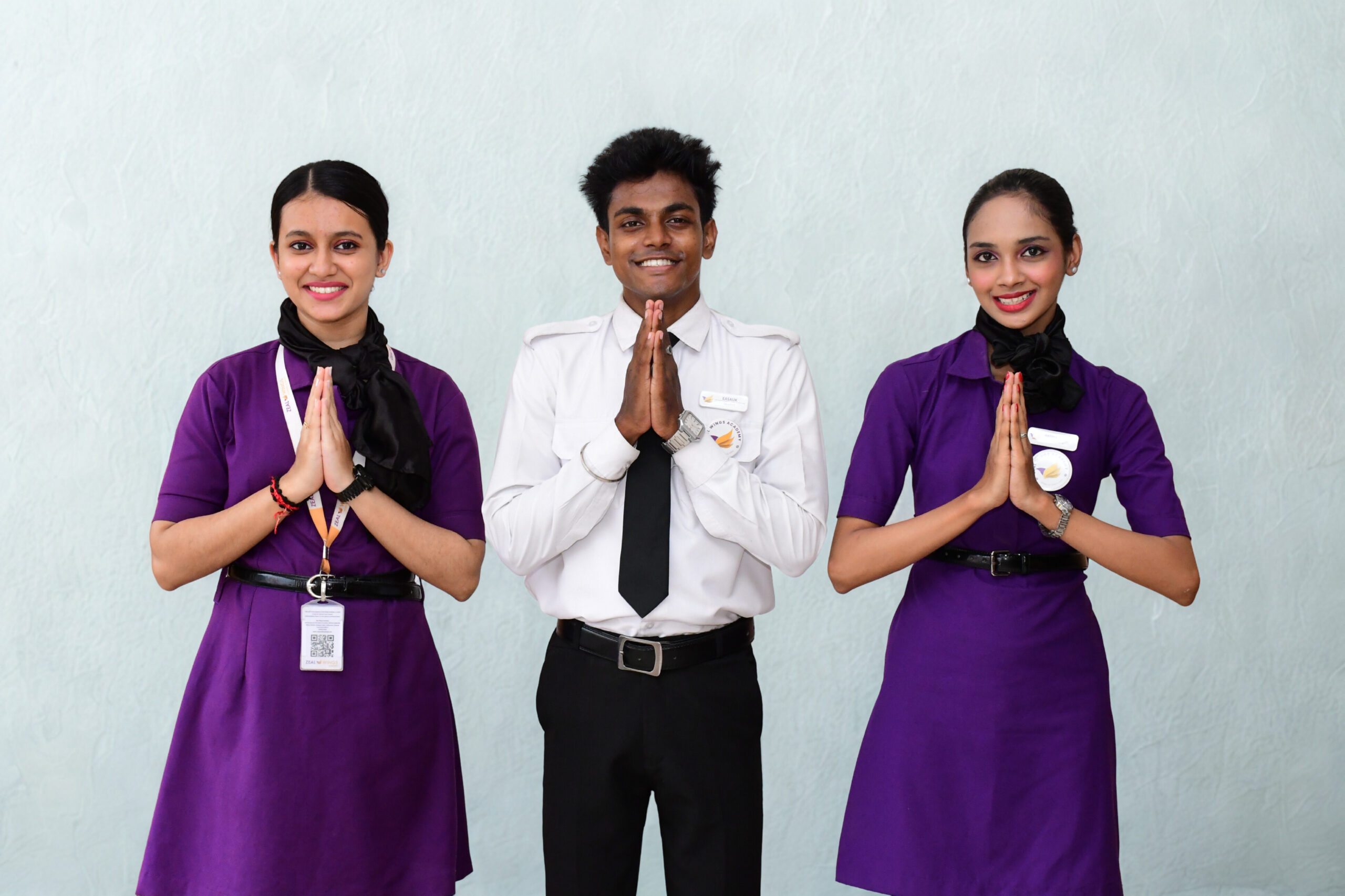 Aviation students in uniform greeting with namaste at Zeal Wings Academy Chennai