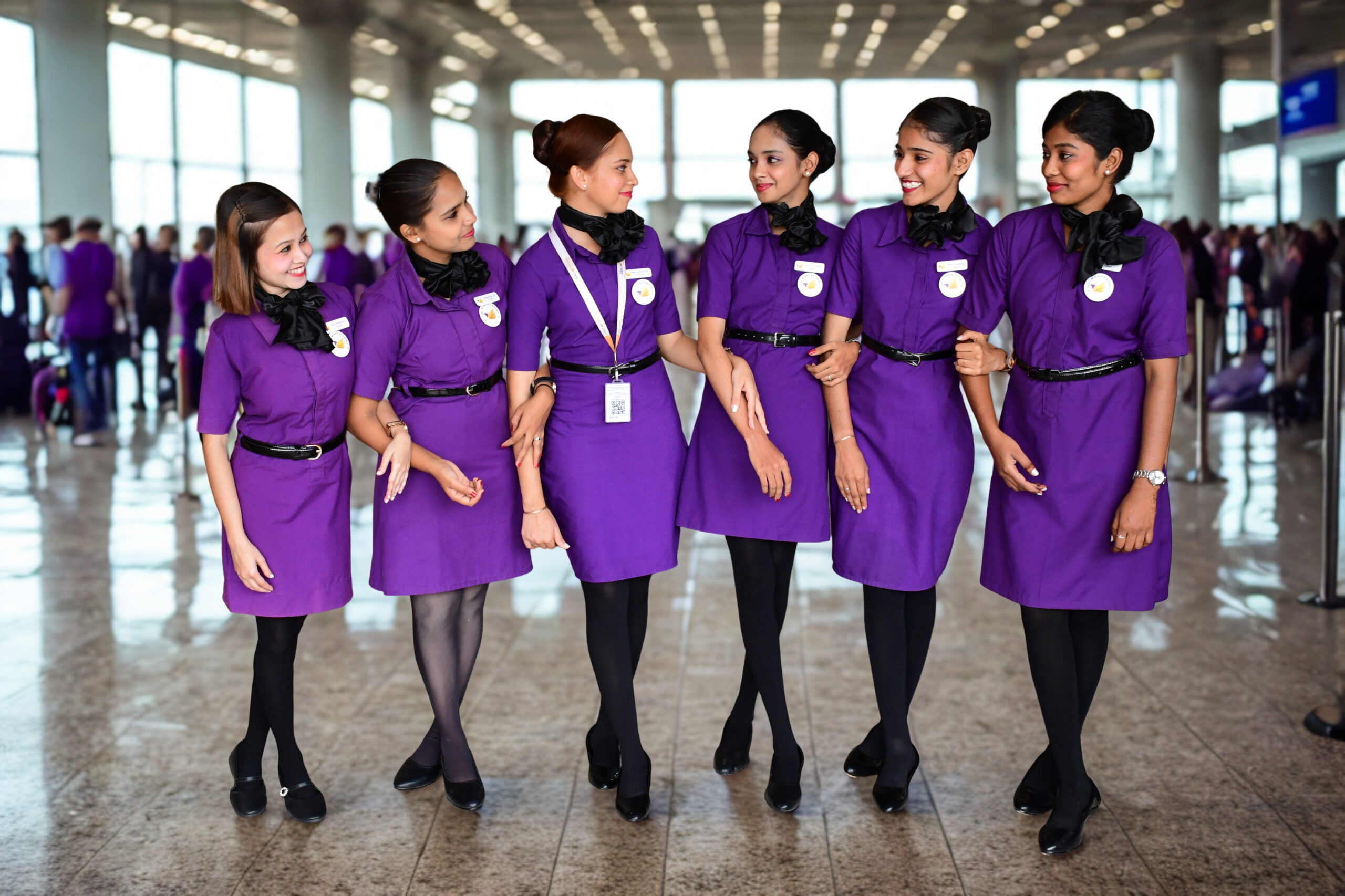 Aviation academy students in cabin crew uniform learning professional skills for an air hostess career.