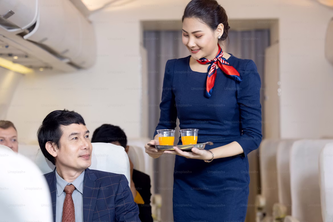 cabin crew member showing professional cabin crew skills while assisting passenger on a flight