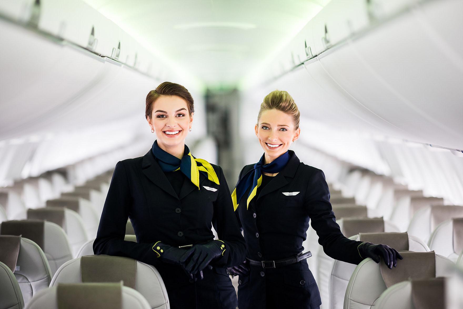 Cabin crew members showing professional cabin crew skills inside an airplane