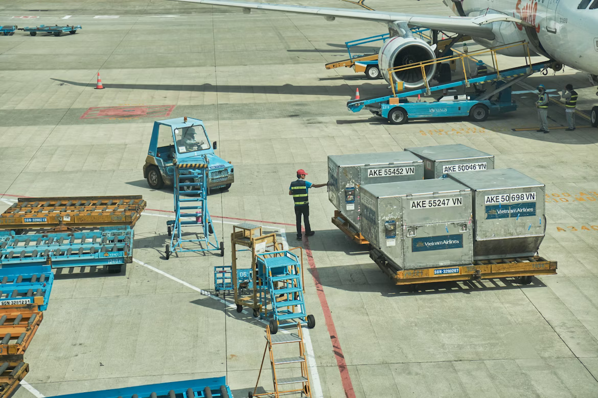Airport ground staff member working near an aircraft in the air cargo industry and aviation operations.